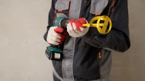 Construction worker holding cordless drill and mixing paddle attachment Stock Photos