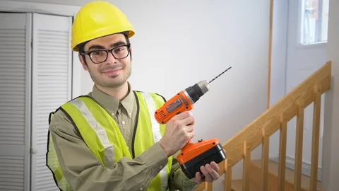Construction Worker Holding a Drill and Looking at The Camera Stock Footage 103780500