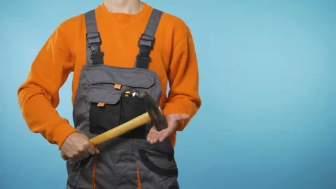 Construction worker holding a hammer in his hands Stock Footage 143596322
