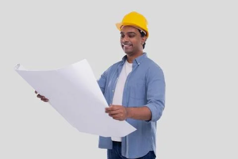 Construction Worker Holding House Plan in Hands Watching at it. Architect Stock Photos