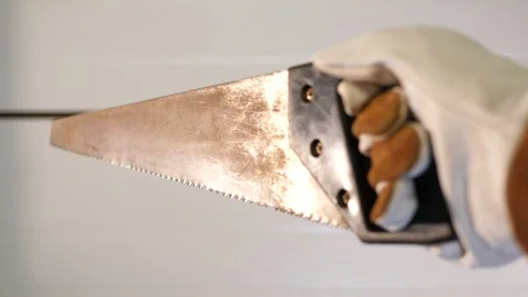 Construction worker holding old rusty hand Saw. Home worker brown gloves POV. Vídeos de archivo 126338549