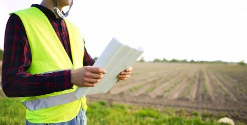 Construction worker holding plan construction plan. Stock Photos