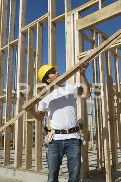 Construction Worker Holding Up Plank Stock Photos