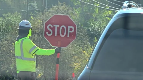 Construction Worker Holding Stop Sign Stock Footage 321885329