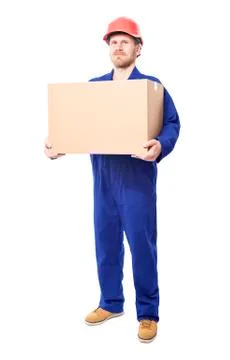 Construction worker holds carton box. Isolated on white. Stock Photos