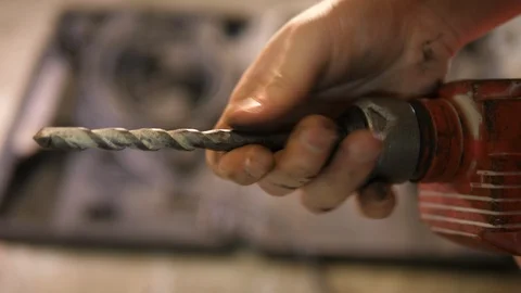 Construction worker inspecting big old wired electric rusty Drilling bit tool Stock-Footage 126343412
