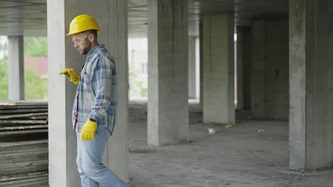 Construction worker inspecting concrete column on building site Stock-Footage 337467366