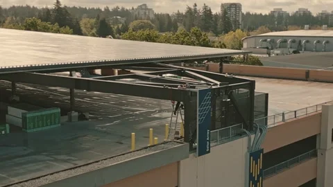 Construction worker inspecting solar array framework on parking garage captured 스톡 동영상 333942585