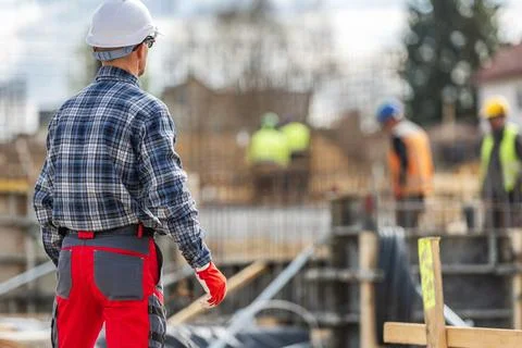 Construction Worker Inspects Site During Active Building Process Stock Photos