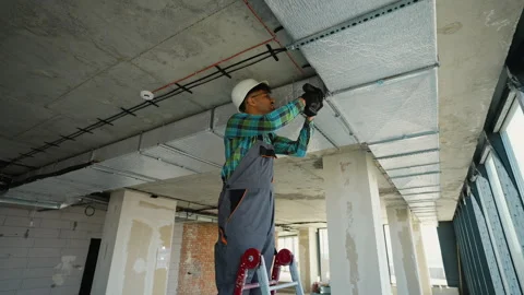 Construction worker installing air conditioning system on a ladder Stock Footage 312837894