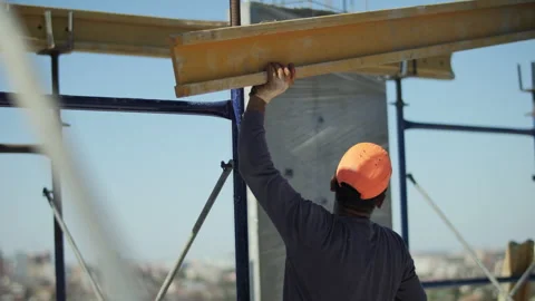 Construction worker installing beam on building site Stock Footage 318779767