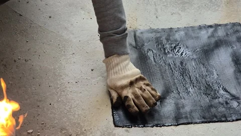 Construction worker installing bituminous waterproofing membrane on flat roof 스톡 동영상 345666458