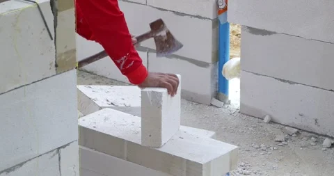 Construction worker installing blocks at a building site action sequence Stock Footage 332790463