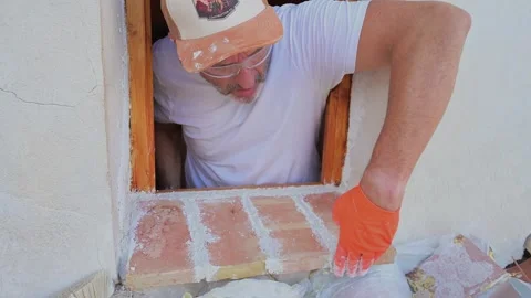 Construction worker installing a brick window sill Stock-Footage 346167986