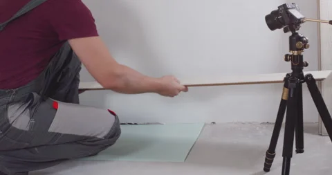 Construction worker installing laminate flooring planks Stock Footage 303712539