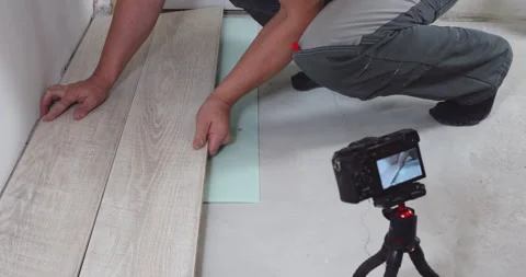 Construction worker installing modern laminate floor in house Stock Footage 295194944