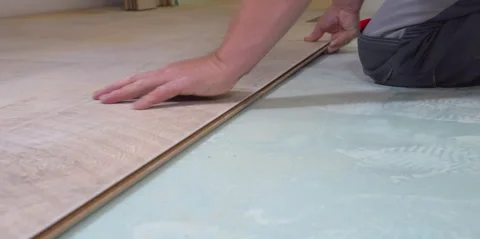 Construction worker installing modern laminate wood flooring Stock Footage 298324340
