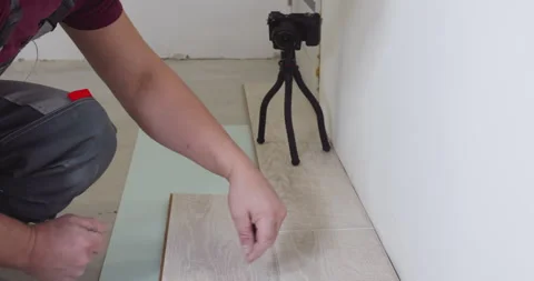 Construction worker installing new laminate flooring Stock Footage 295194183