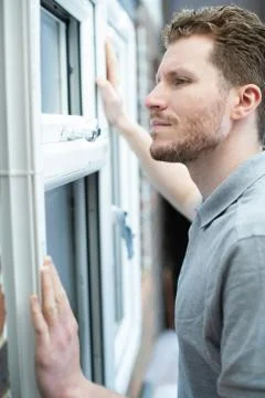 Construction Worker Installing New Windows In House 写真素材