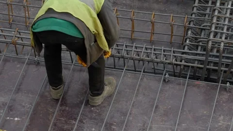 Construction Worker Installing Rebars on High-Rise Stock Footage 333409145