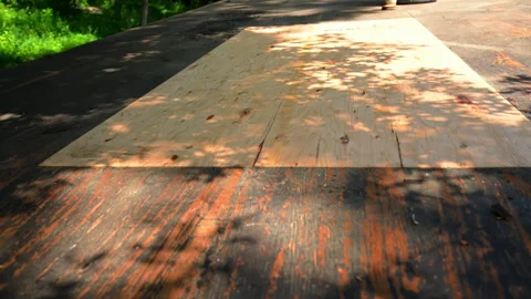 Construction worker installing roofing underlayment on a roof deck using OSB Stock Footage 341548592