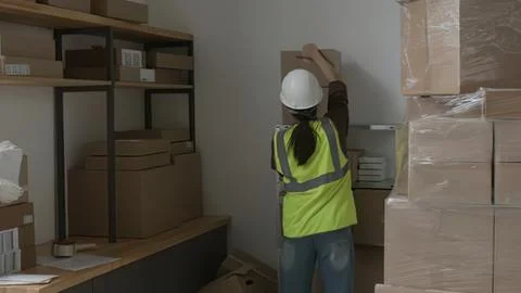 Construction worker installing shelves in a storage room Stock Photos