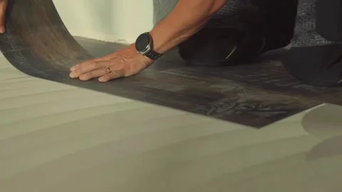 Construction worker installing vinyl laminate flooring Stock Footage 316389580