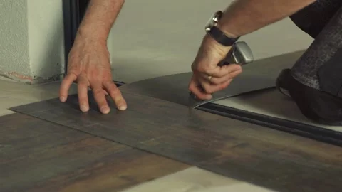 Construction worker installing vinyl laminate flooring Stock Footage 316389609