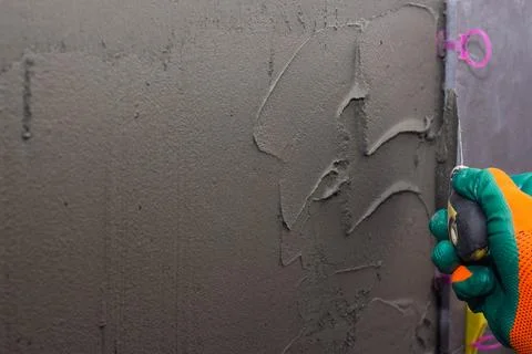 Construction worker installing wall tile at home repair renovation work Stock Photos