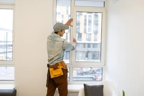 Construction worker installing window in house Stock Photos