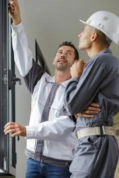 A construction worker installing window Stock Photos