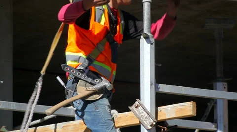 Construction worker installs a structural beam at development site Video stock 34371426