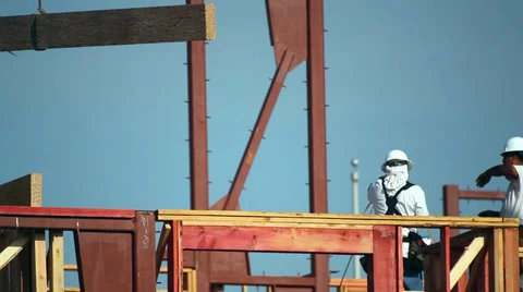 Construction worker installs a structural beam coming from the crane Vídeos de archivo 34577686
