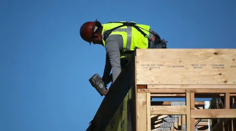 Construction worker installs the wall at development site Stock Footage 34085054