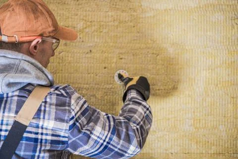 Construction Worker Insulating House.  Stock Photos