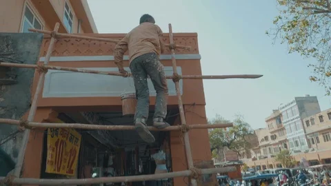 A construction worker in Jaipur, India without Safety Gear working at a Stock Footage