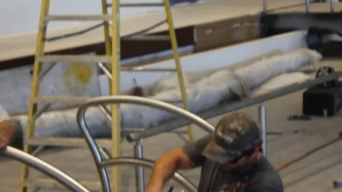 Construction worker at job site shaving metal to smooth out weld A 스톡 동영상 115452742