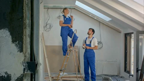 Construction worker on ladder in house Stock Footage 90734121