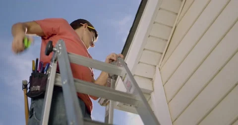 Construction worker on ladder measuring Stock Footage 145175913