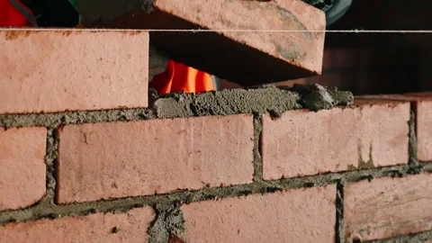 Construction Worker Laying Brick on Fresh Cement Mortar Stock Footage 343360346