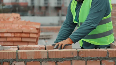 Construction worker laying bricks on a wall, Close-up of a construction worker Stock Footage 301557453