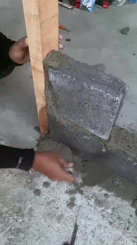 Construction worker laying concrete blocks with cement mortar at building site. Stock Footage 318744748