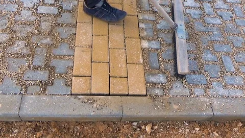 Construction worker laying interlocking paving concrete onto sheet nonwoven b 스톡 동영상 113446342