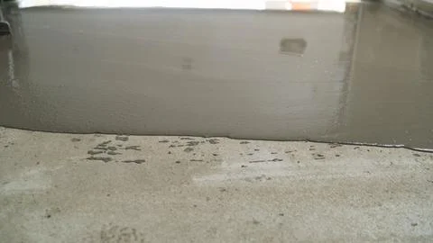 Construction worker leveling concrete surface Stock Photos