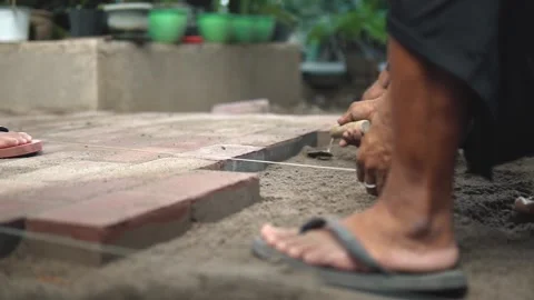 Construction Worker Leveling Sand Layer for Bricks  Stock Footage 160036339