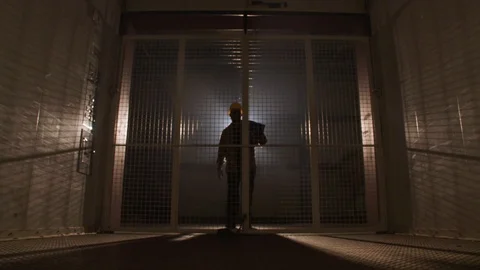 Construction Worker Lifting Elevator Gate Stock Footage 127329370