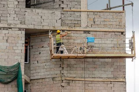 Construction worker at lifting platform Stock Photos