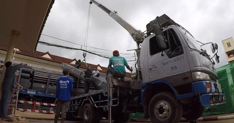 Construction worker loading stack of steel bars Stock Footage 93941878
