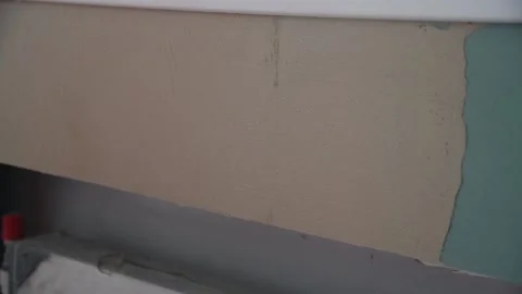 Construction worker with long trowel plastering a wall Stock Footage 155539613