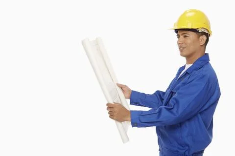 Construction worker looking at a blueprint plan Stock Photos